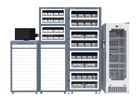 Laboratory equipment setup including a monitor, storage cabinets with drawers, and a refrigerated unit for sample storage.