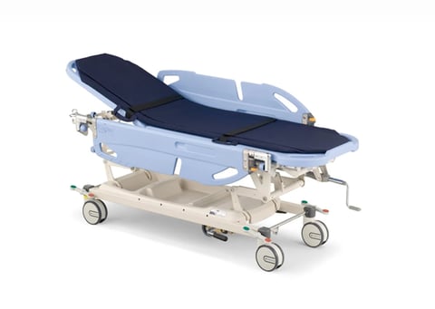 Medical examination stretcher with blue mattress and padding on wheeled beige metal frame
