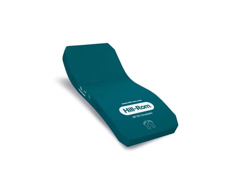 Teal-colored foam cushion with curved ergonomic design and Care-Roam branding label